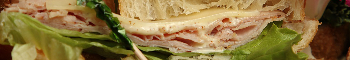 Eating Deli Sandwich at Broadway Gourmet restaurant in New York, NY.